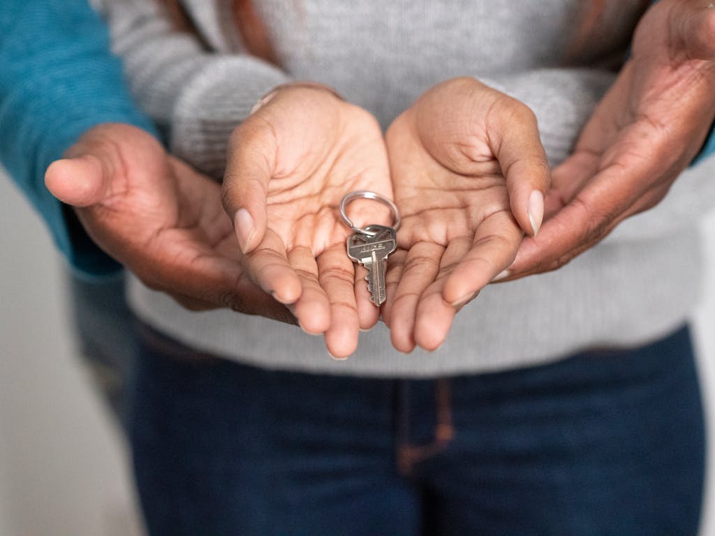 Close-up of hands holding a key, representing homestead protection in Florida and property investment.