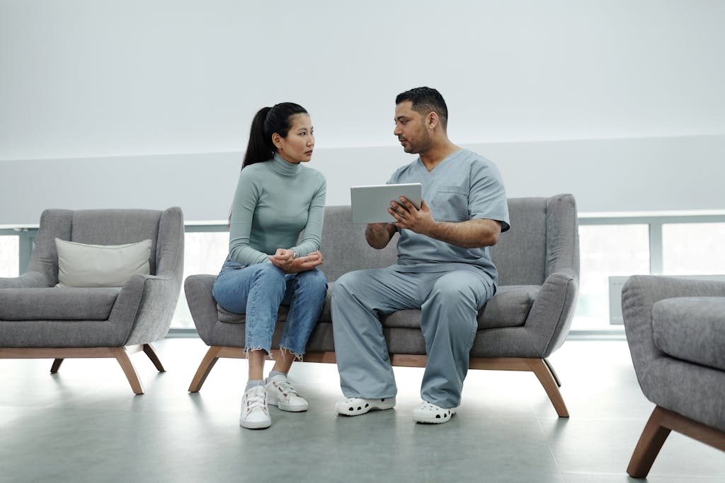 Healthcare provider consulting a patient on getting a health care surrogate with a tablet, emphasizing technology in healthcare.
