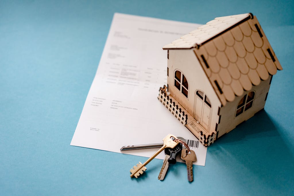 Miniature wooden house with keys and contract symbolizing lady bird deed in Florida.