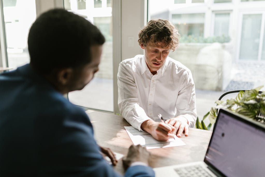 A business contract review attorney reviewing a business contract with a client to ensure his rights are protected.